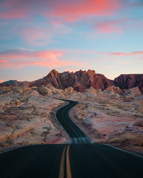 Black Asphalt Road Near Brown Rocky Mountain