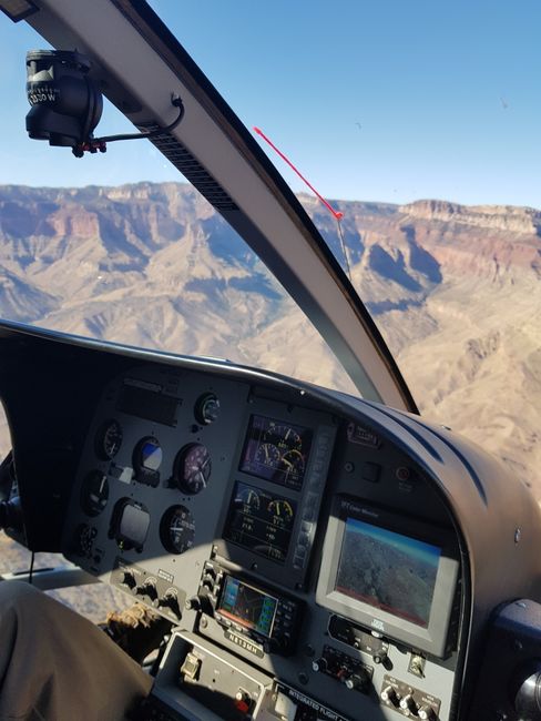 Stunning aerial view from a helicopter dashboard flying over the Grand Canyon's breathtaking landscape