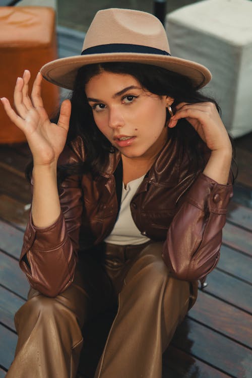 Woman in Brown Leather Jacket Wearing a Hat