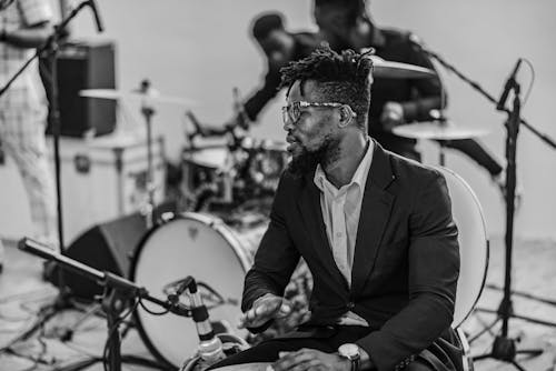 Man in Suit Playing Drums