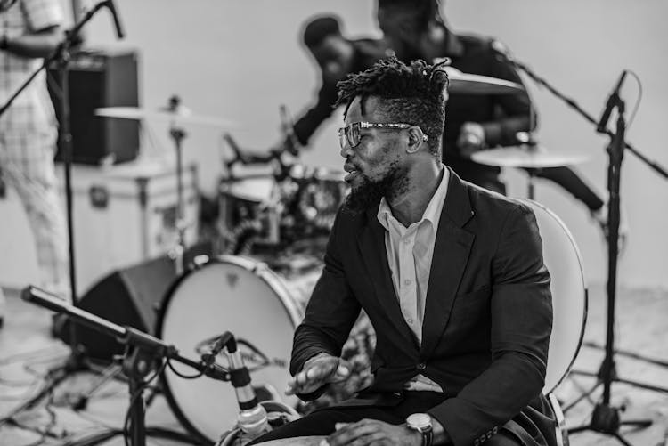 Man In Suit Playing Drums