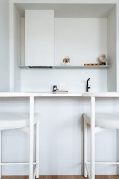 A modern minimalist kitchen interior in Saint Petersburg with white furniture and clean lines.