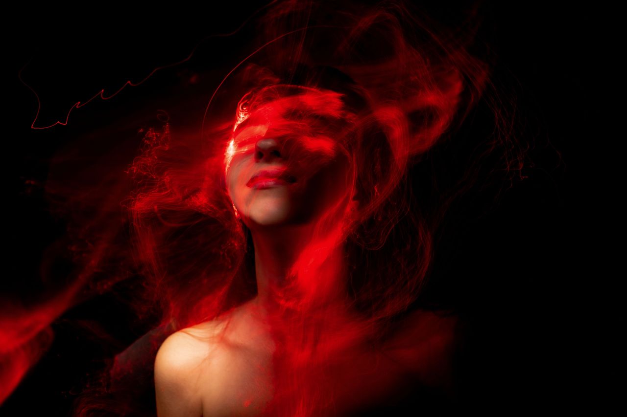a creative abstract portrait featuring vibrant red neon effects envelo