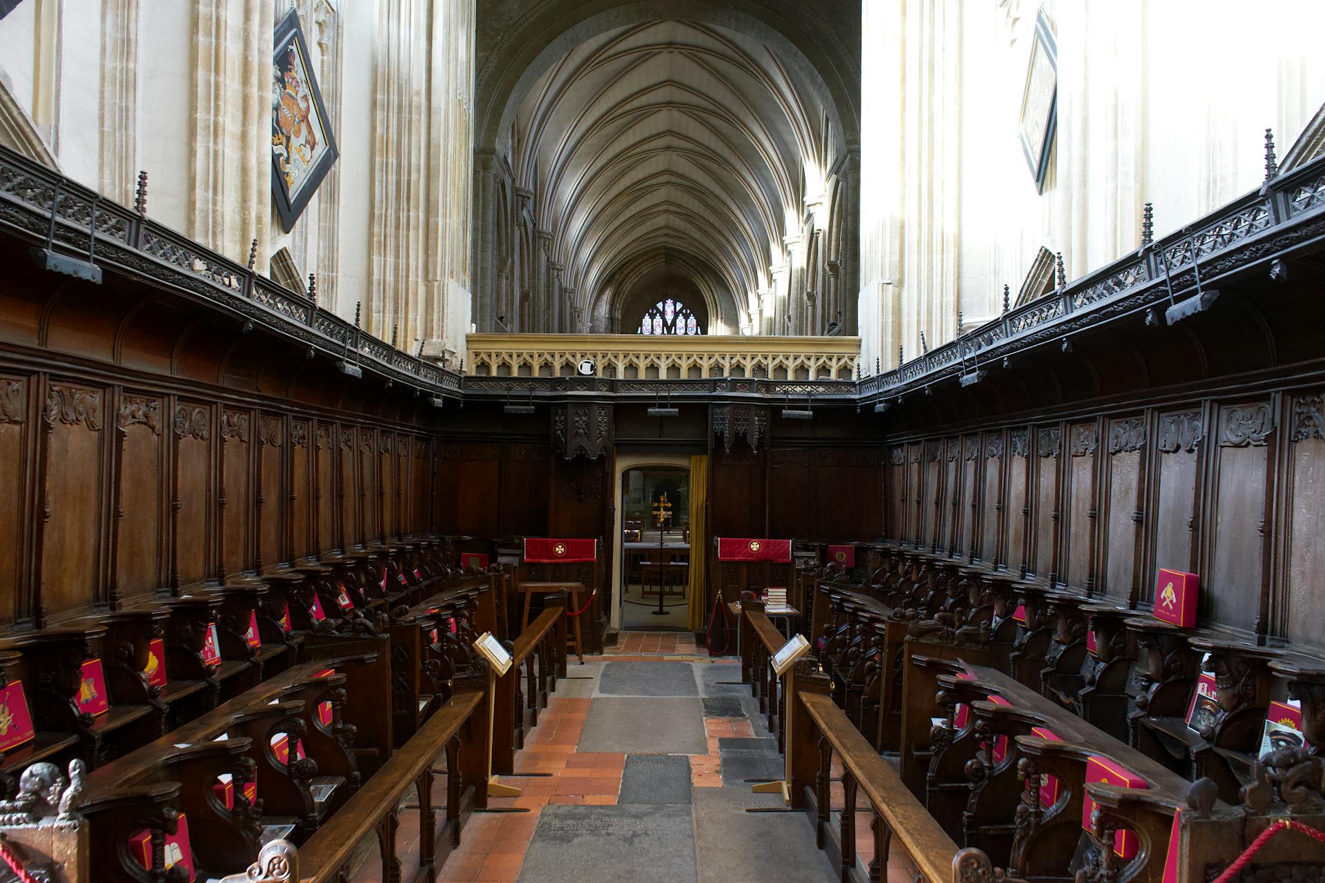 Explore the majestic wooden pews and gothic architecture inside a historic English cathedral.