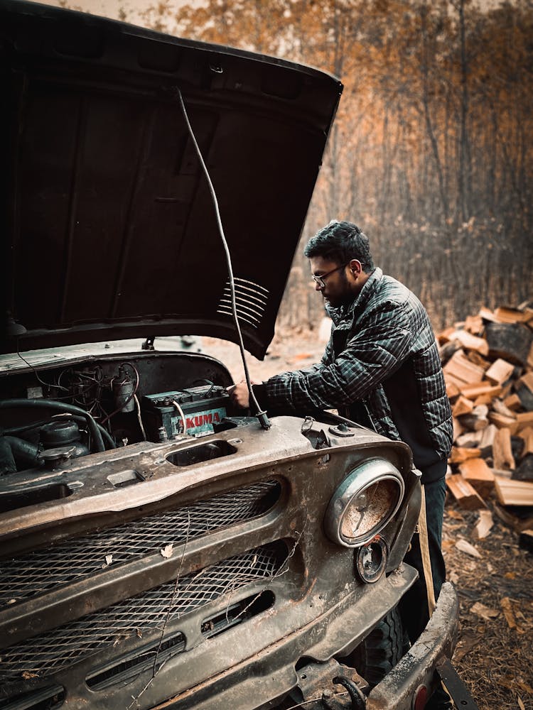 A Man Fixing A Car