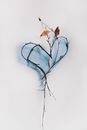 Branch with Leaves on White Background Bent in Heart Pattern