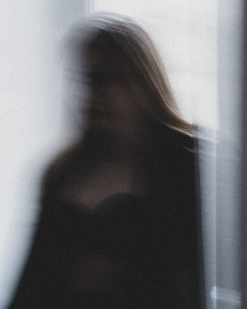 Free Artistic blurred silhouette of a woman creating an ethereal and mysterious effect. Stock Photo