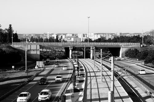 Grayscale Photo of Cars on the Road