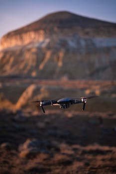 Drone flying over a scenic Kazakhstan mountain landscape at twilight, capturing serene aerial views.