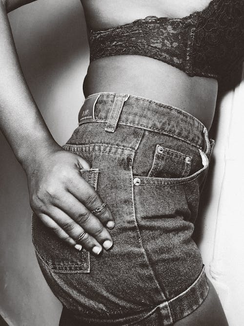 Grayscale Photo of a Person Wearing Denim Shorts