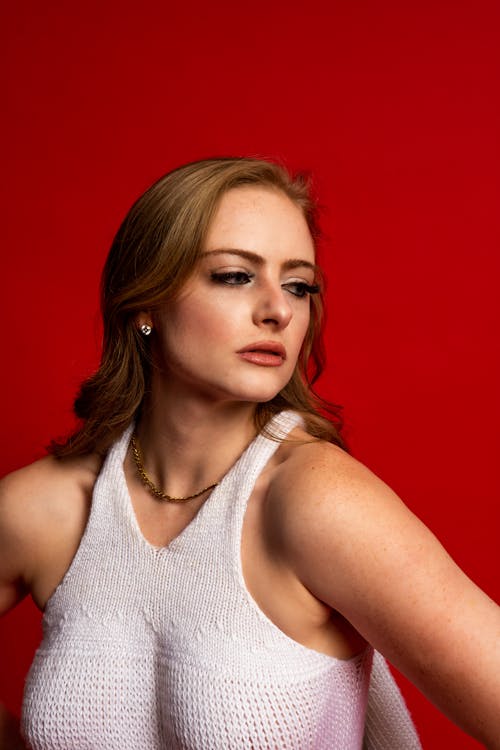  A Woman Wearing a White Knitted Tank Top