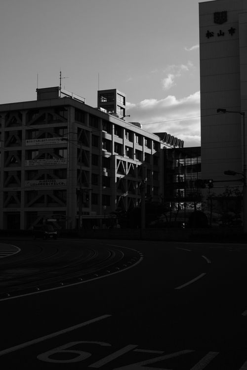 Free A striking black and white cityscape showcasing urban architecture against the evening sky. Stock Photo