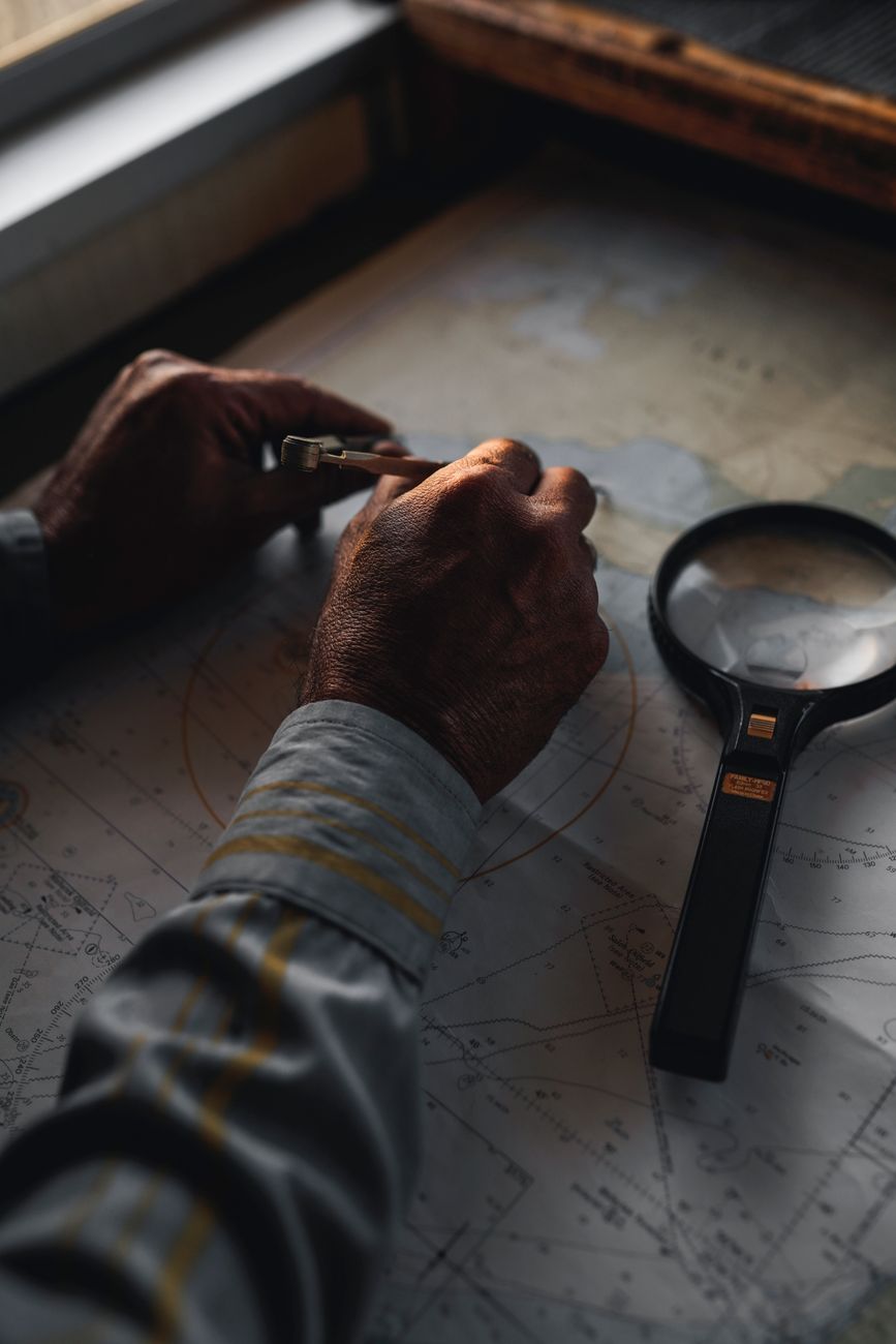 A compass resting on an open map at a desk