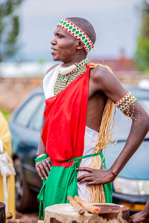 Free Man wearing vibrant traditional clothing, standing outdoors, showcasing cultural heritage. Stock Photo