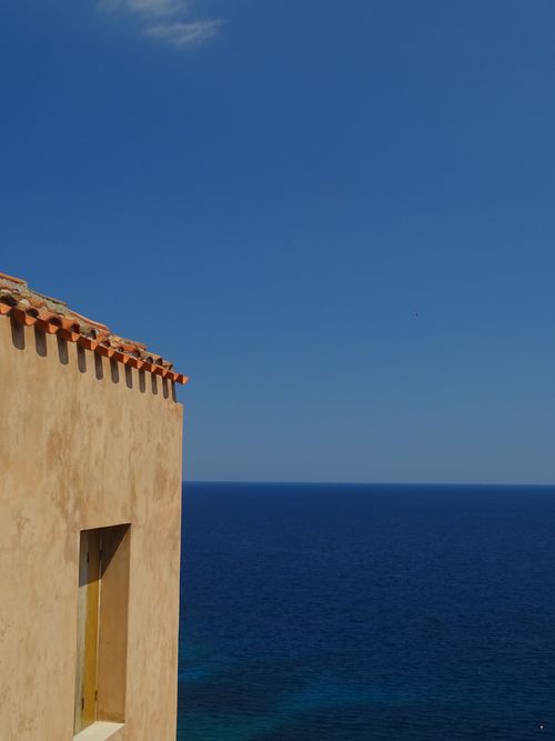 Free Serene view of the Mediterranean Sea from a traditional house in Monemvasia, Greece. Stock Photo