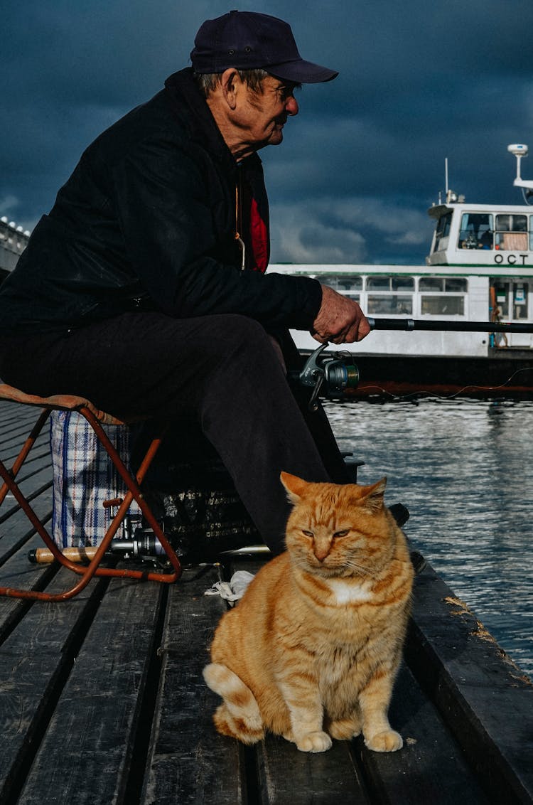 Elderly Man Sitting With Cat 