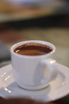 A steaming cup of Egyptian coffee on a saucer, offering a warm and inviting moment.