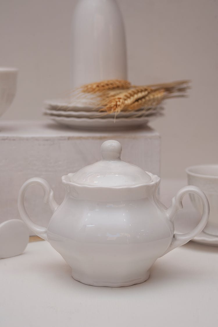 A White Ceramic Teapot On White Table