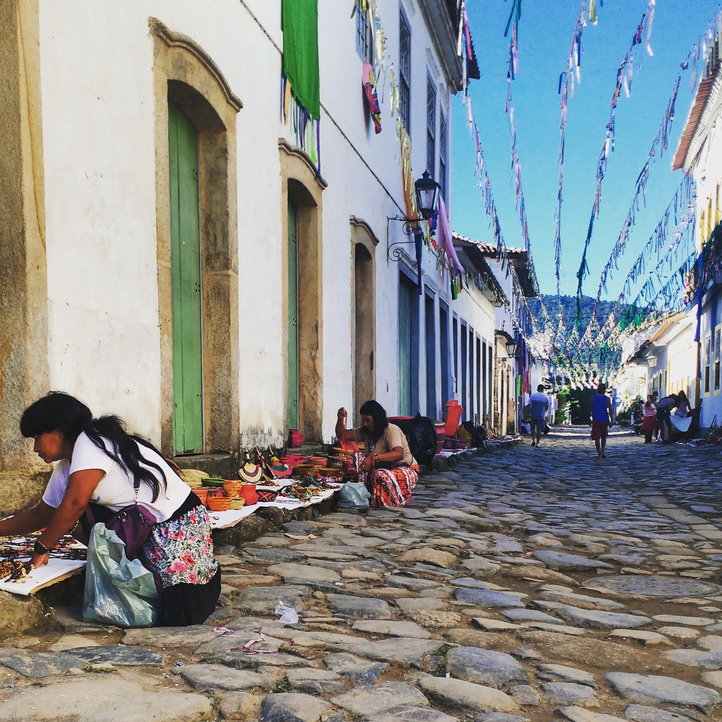 Vendors on a Cobblestone Street
