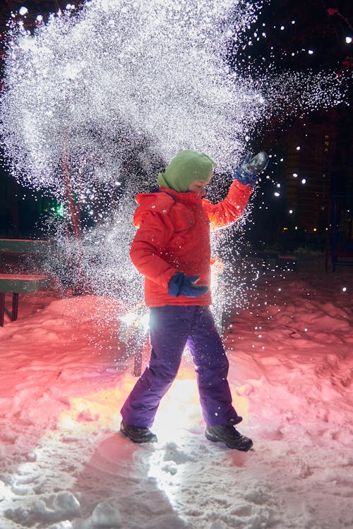 Free Boy in Red Hoodie and Black Pants Playing With Water Stock Photo