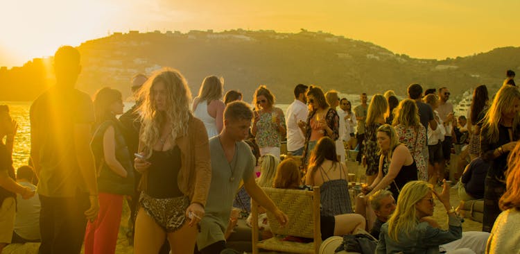 Crowd Of People Gathering During Golden Hour