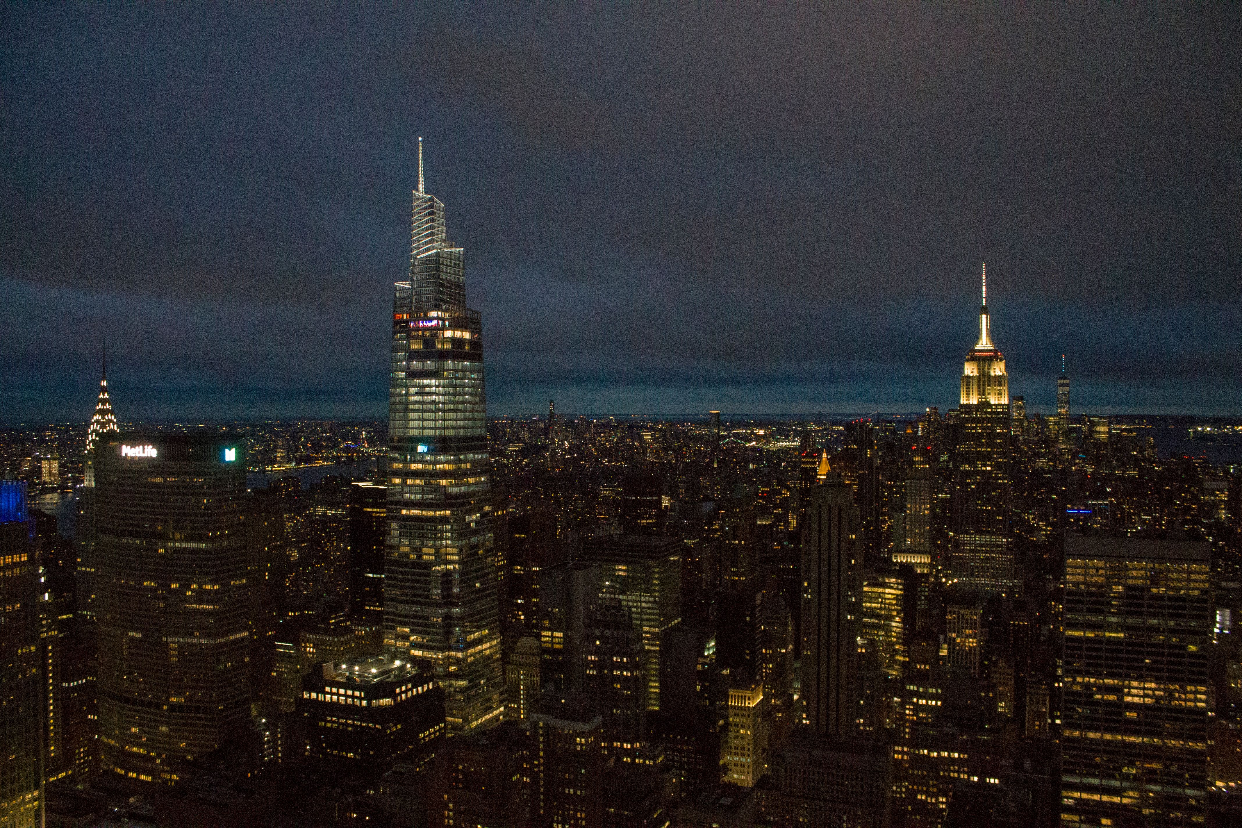 A stunning view of New York City's illuminated skyline showcasing iconic skyscrapers under a night sky.