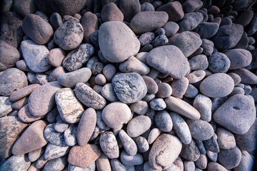 A detailed close-up of smooth, textured stones creating a natural background.