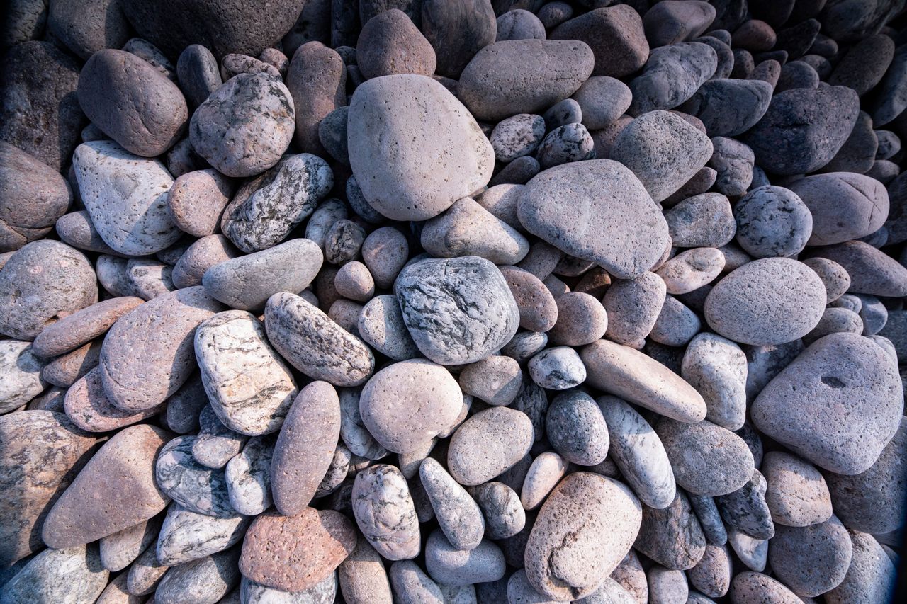 a detailed close up of smooth textured stones creating a natural backg