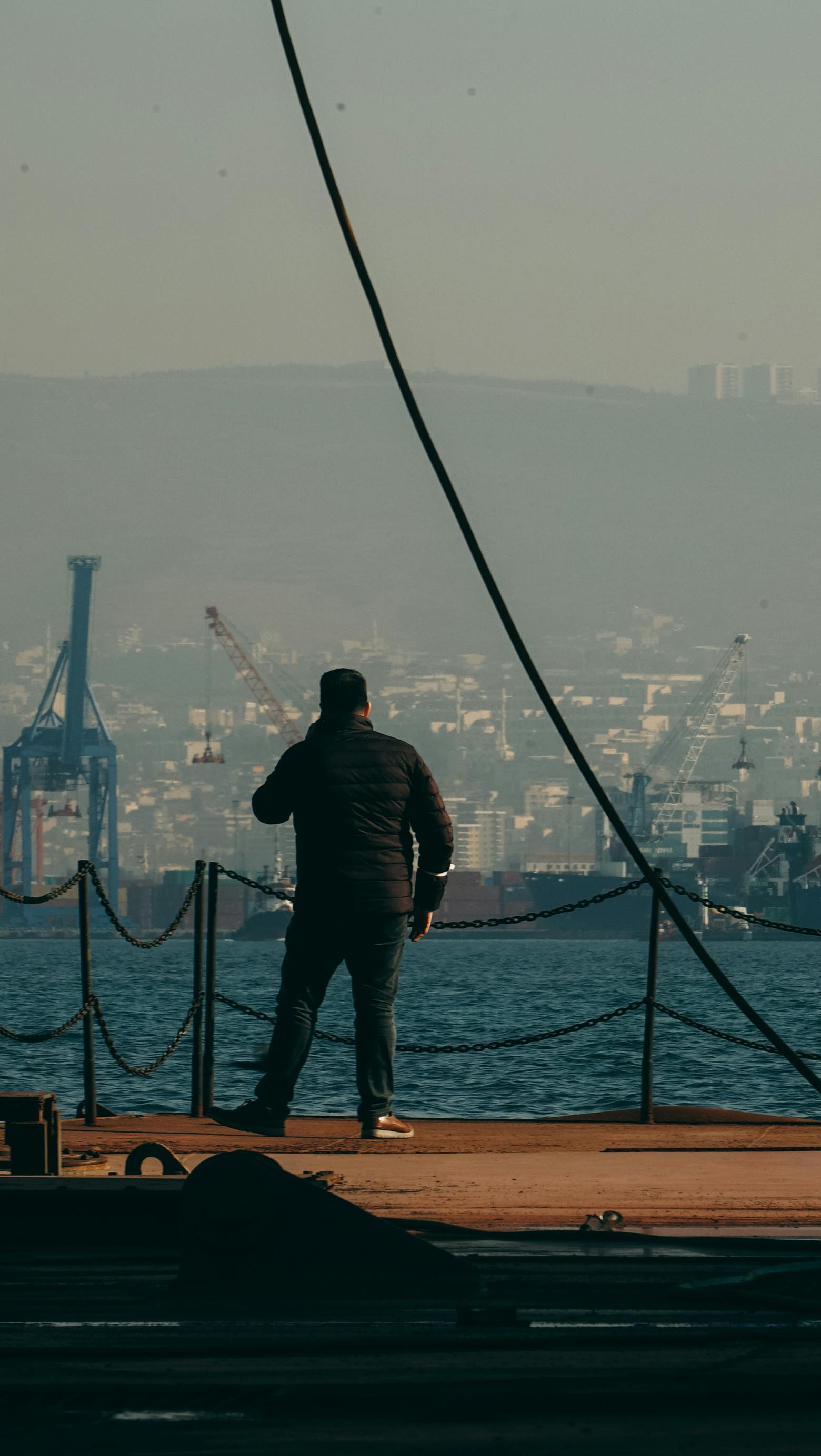 Man in Black Jacket Standing on Dock · Free Stock Photo