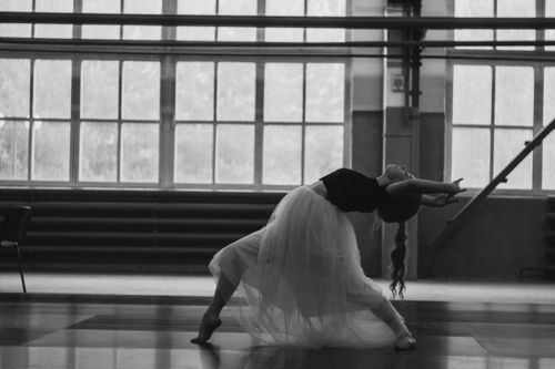 Free Captivating black-and-white image of a young ballerina performing indoors. Stock Photo
