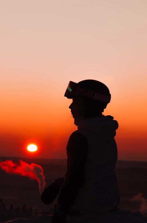 Silhouette of a Person Wearing a Hat during Sunset
