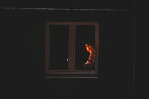 A Man Standing near the Window