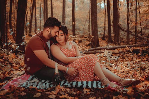 Free A Romantic Couple Embracing in the Forest Stock Photo