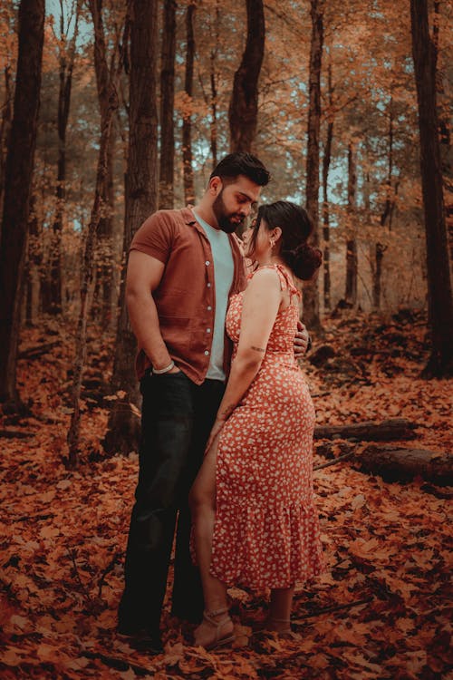 A Couple Standing on Fallen Leaves 