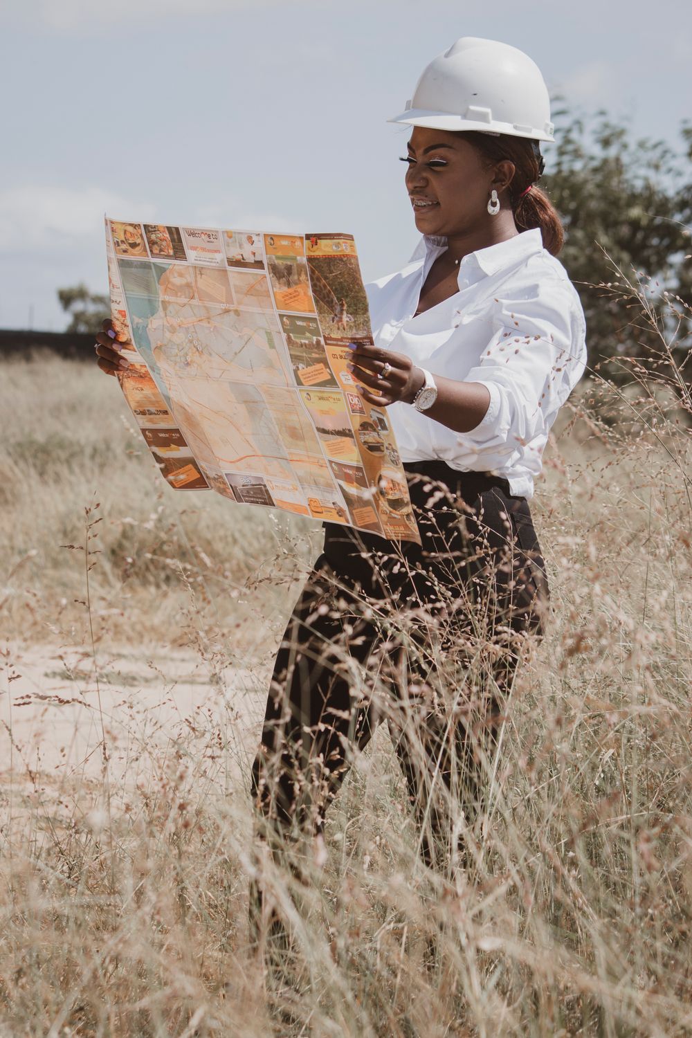 An engineer reviewing plans in the field