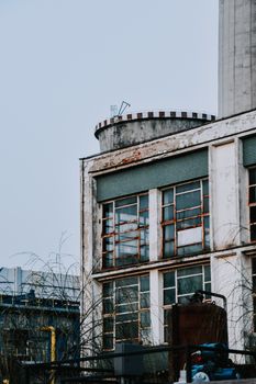 Close-up of a rusted, abandoned building showcasing industrial decay and vintage architecture.