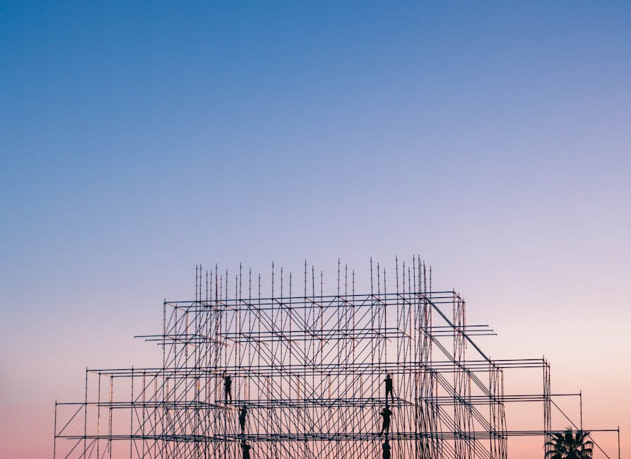 A silhouetted structure against a colorful sunset, showcasing industrial scaffolding in Sochi, Russia.