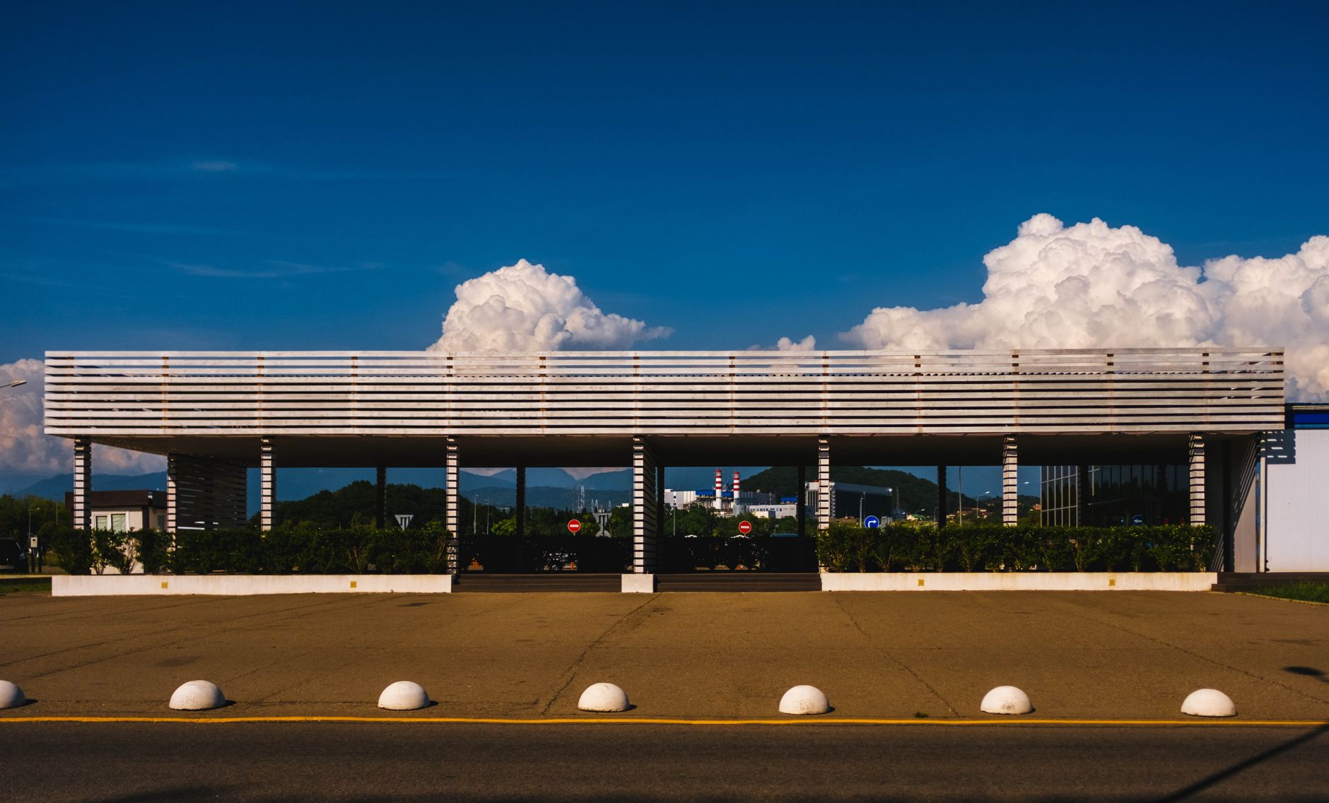 A modern pavilion with a blue sky and clouds backdrop in Sochi, Russia.
