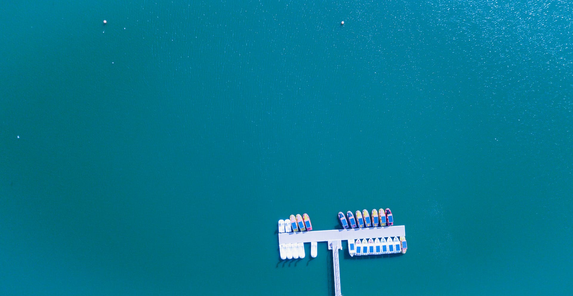 Aerial view of multiple colorful boats docked at a marina in Dubai's vibrant waters.