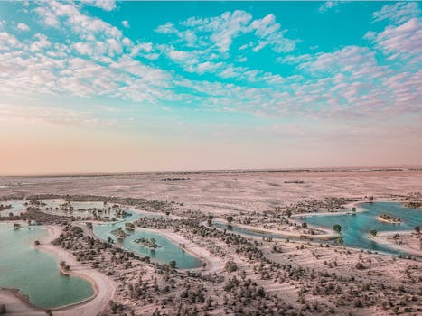 Stunning aerial view of Al Qudra Lakes surrounded by desert in Dubai, UAE.