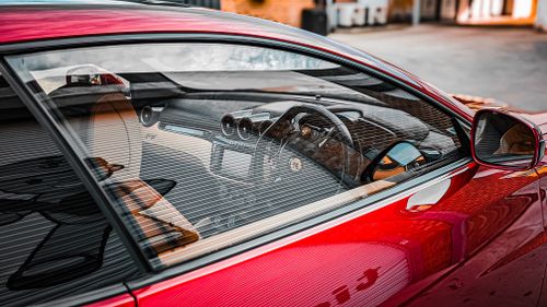 Free Close-up view of a luxury sports car interior with a focus on the dashboard and steering wheel. Stock Photo