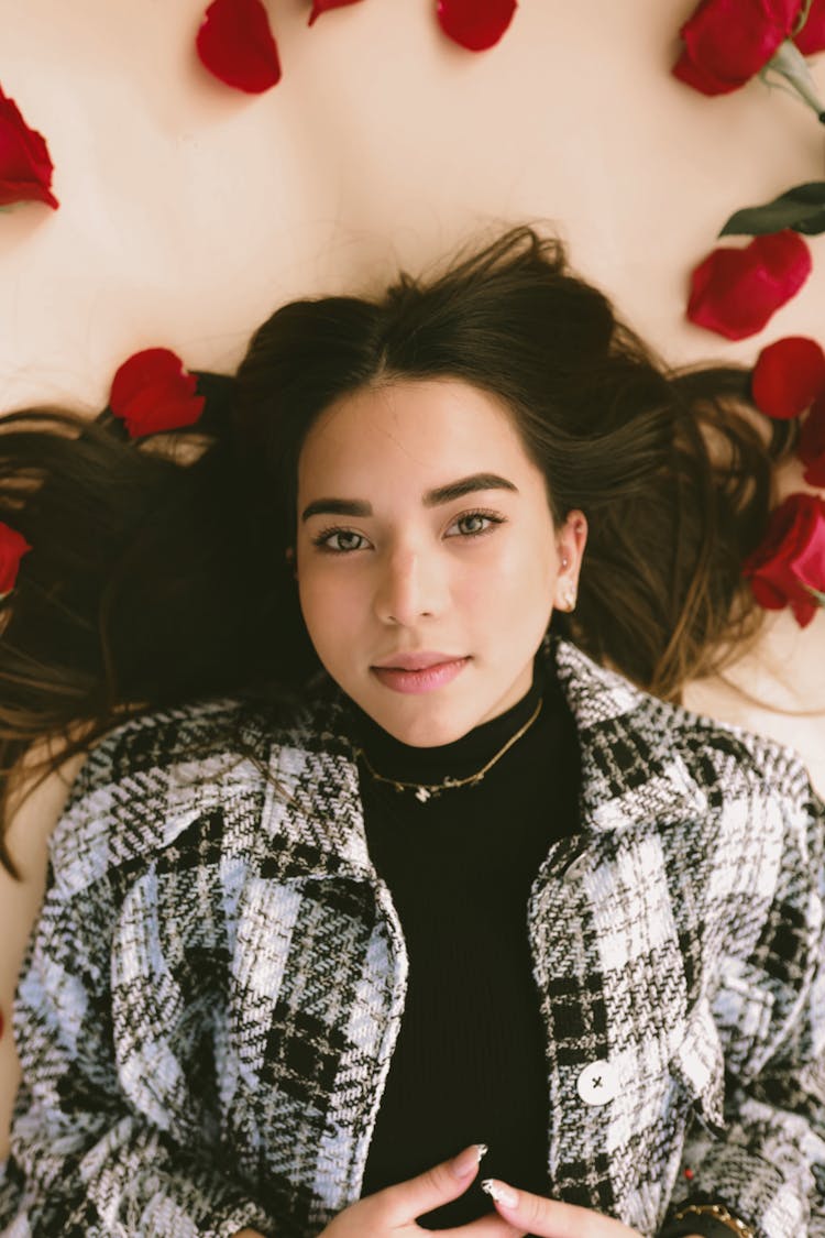 Woman Lying Surrounded By Rose Petals