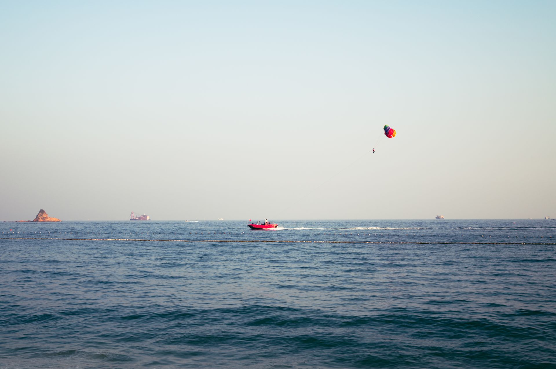 Thrilling parasailing over the vast sea in Shenzhen, capturing leisure and adventure.