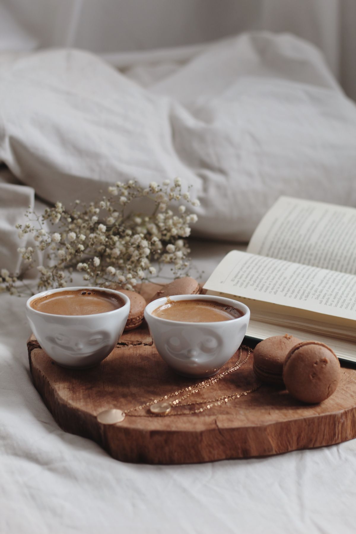 Two cups of coffee on a tray in bed — cosy intimate morning