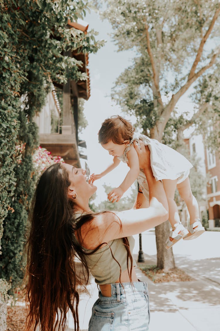 Woman Lifting Her Adorable Baby