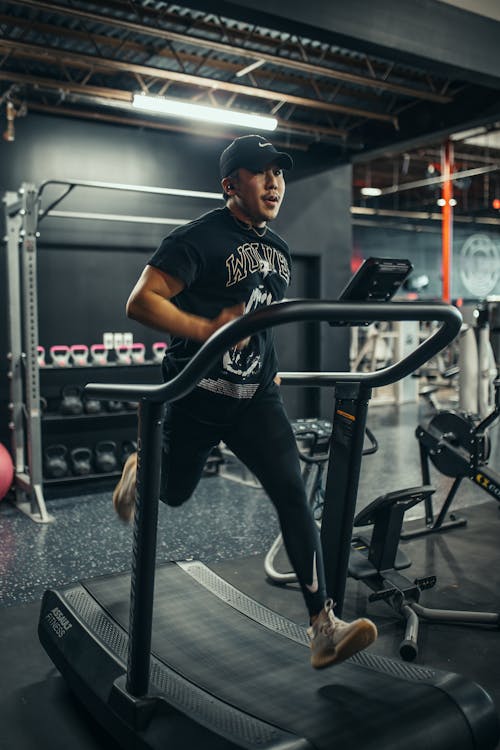 Man Training on Treadmill in Gym