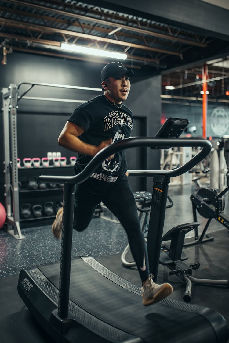 Man Training On Treadmill In Gym