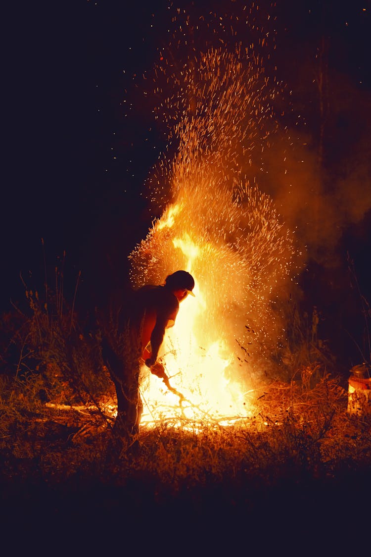 Man By Bonfire At Night