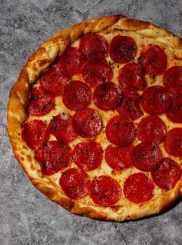 Mouthwatering pepperoni pizza with crispy crust on a rustic table. Perfect for food lovers.