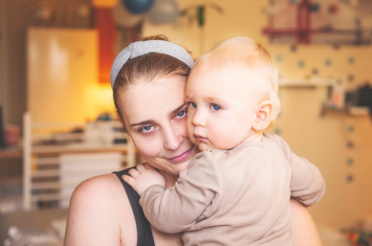 A Woman Carrying Her Baby 